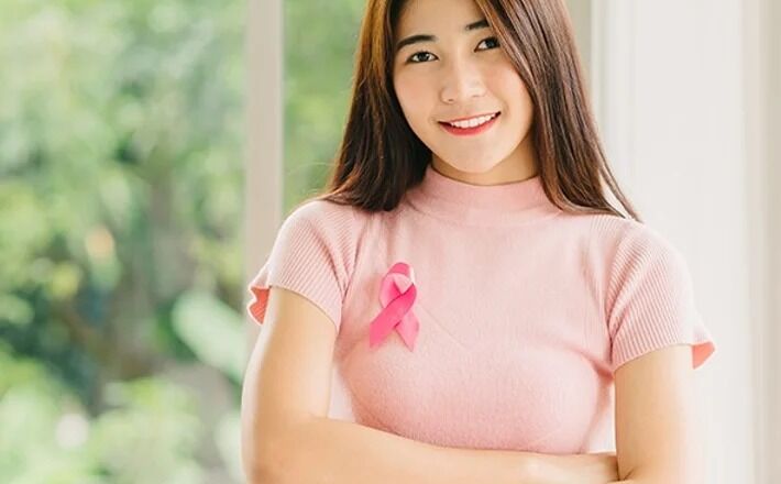 woman with pink ribbon on chest